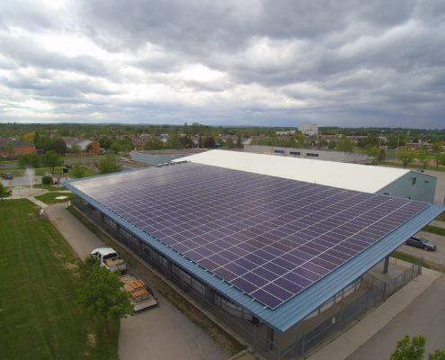 Commercial building with solar panels on the roof, generating renewable energy.