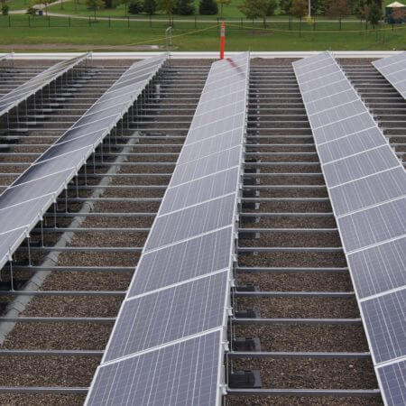Commercial building with rooftop solar panels installed, utilizing solar energy for power.