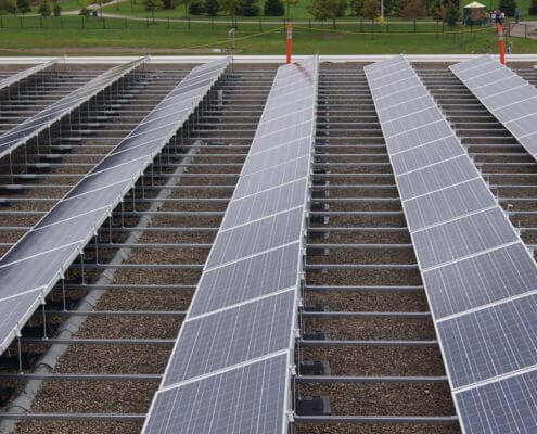Commercial building with rooftop solar panels installed, utilizing solar energy for power.