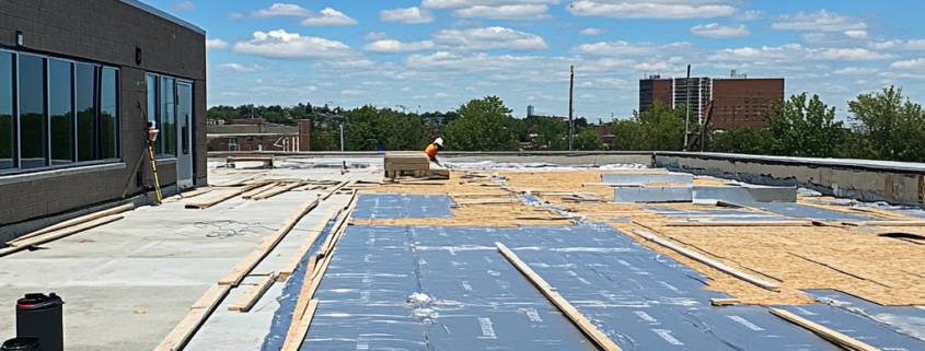 Flat roof construction process on a commercial building in Ontario