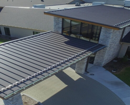 Standing Seam Metal Roof Panels Being Installed