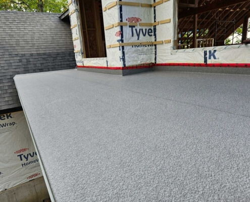 DeckRite vinyl membrane installed on an outdoor deck, showcasing its seamless and water-resistant finish.
