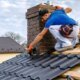 A homeowner discusses essential questions with a roofing contractor on-site.